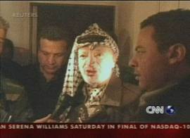 Yasser Arafat sitiado no seu quartel-general em Ramallah,. Imagem: TV CNN em inglês, 30/3/2002